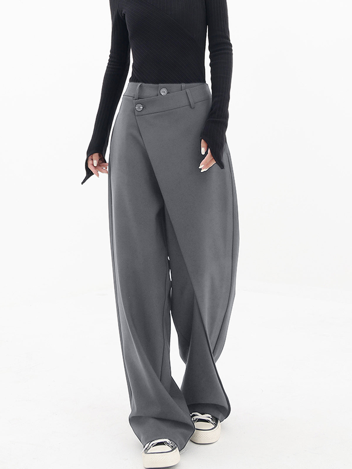Women's beige wide-leg baggy pants with asymmetrical layered hem and button detail for casual wear