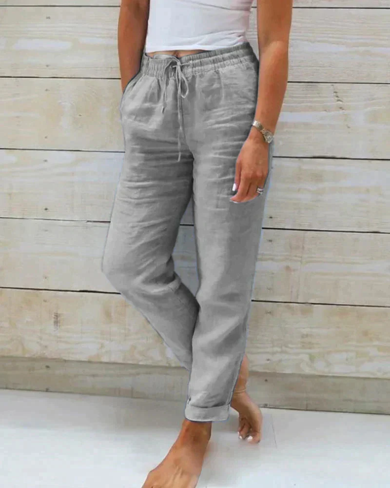 Beige linen straight-cut summer pants with elastic drawstring waistband and rolled legs
