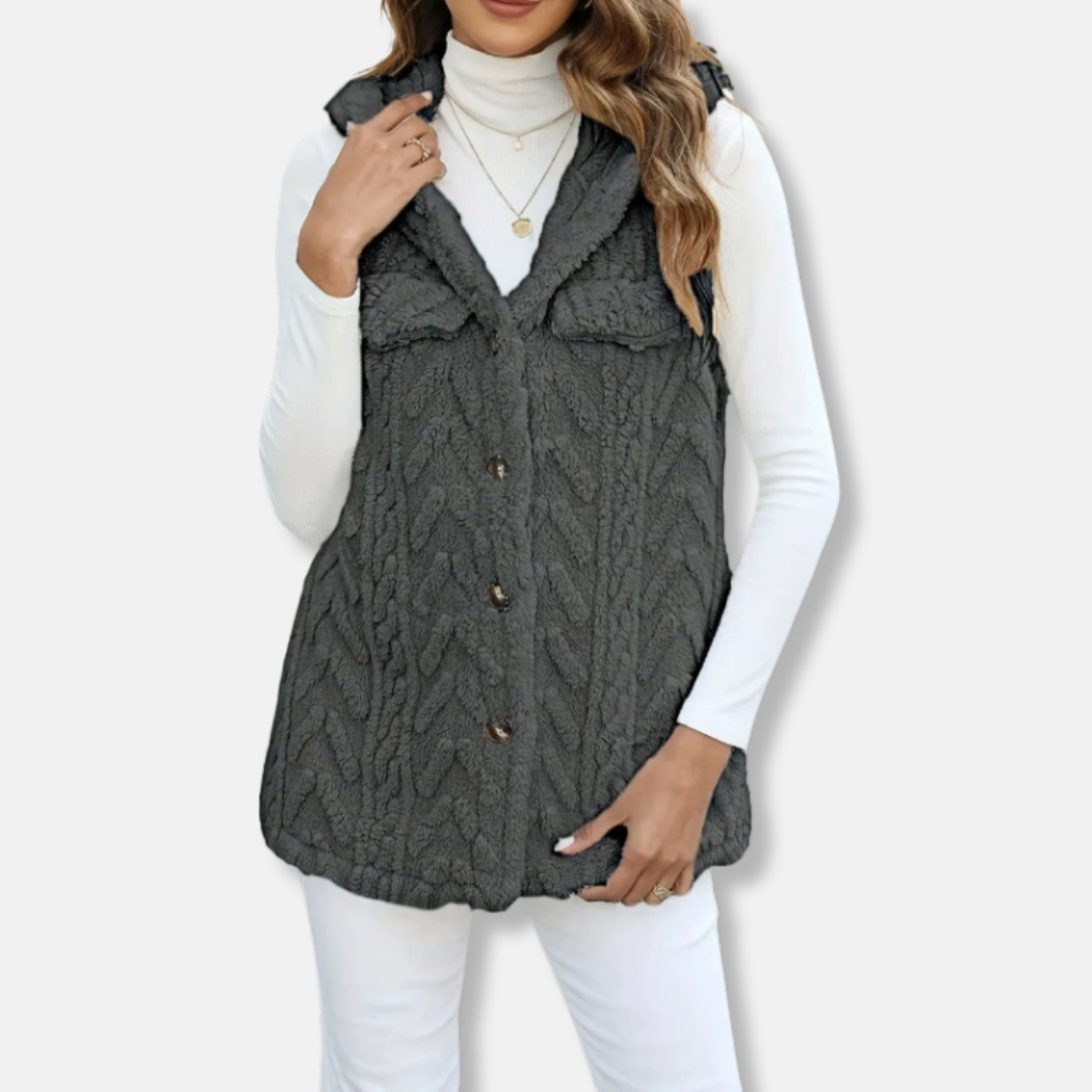 Women's beige cable knit hooded vest with plush fuzzy texture, relaxed fit, and side pockets