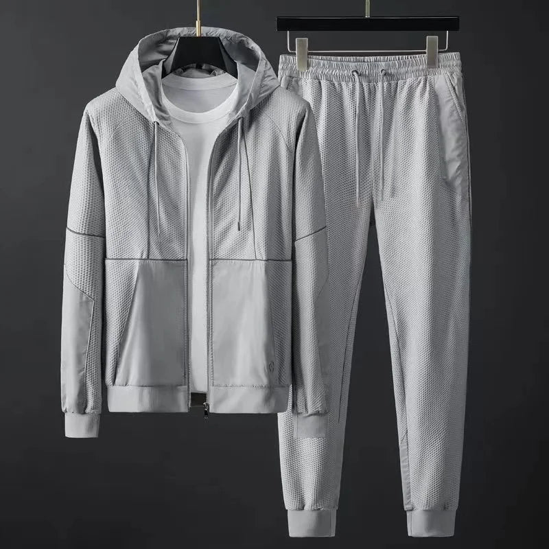 Black athletic tracksuit two-piece set honeycomb mesh panels with matte overlay performance fit