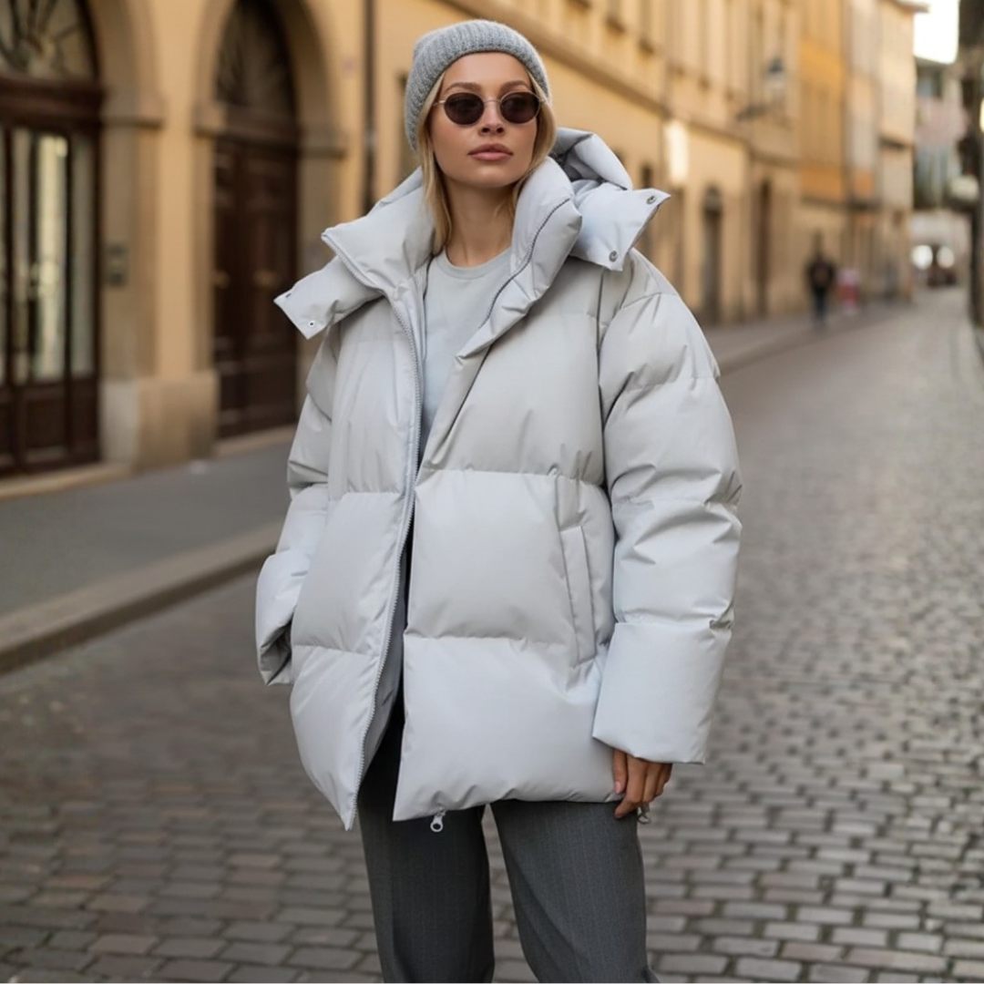 Women's black padded polyester parka with hood, cold-weather insulated coat for warmth and durability