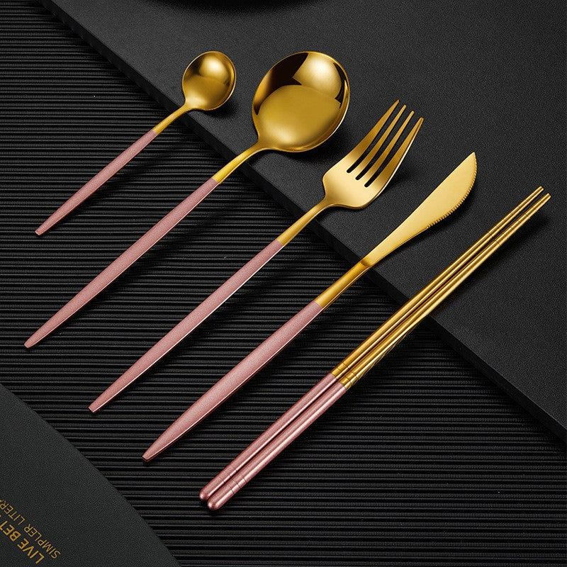 Gold finish stainless steel cutlery set with matte black handles, modern luxury dining design