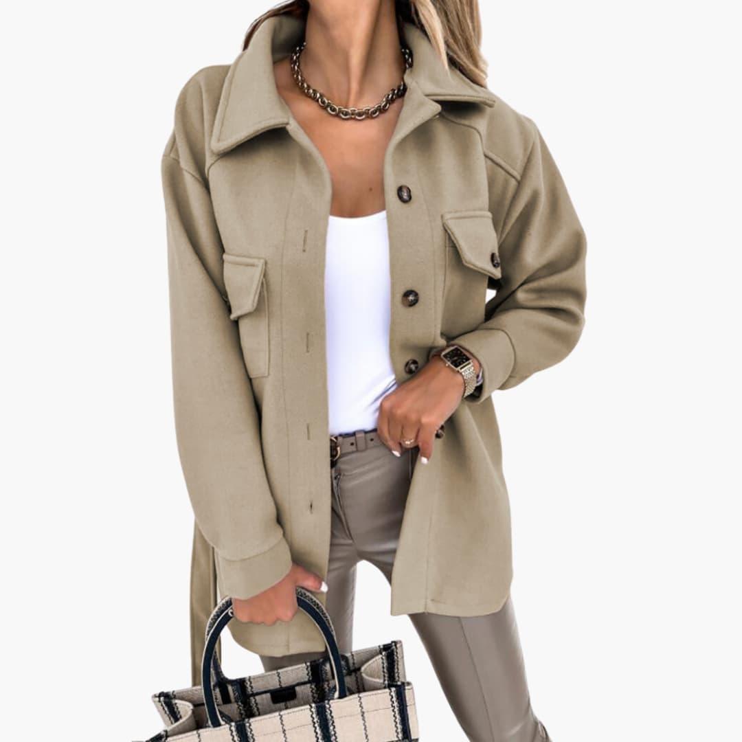 Women's long tailored button-front coat with chest pockets, structured collar, polished workwear style