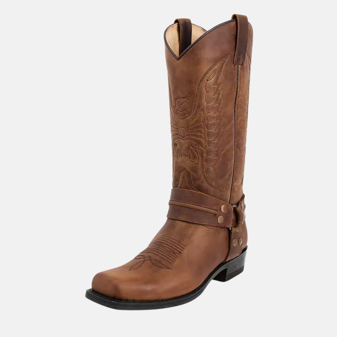 Men's brown leather western boot with embroidered stitching, rugged harness strap, and O-ring detail