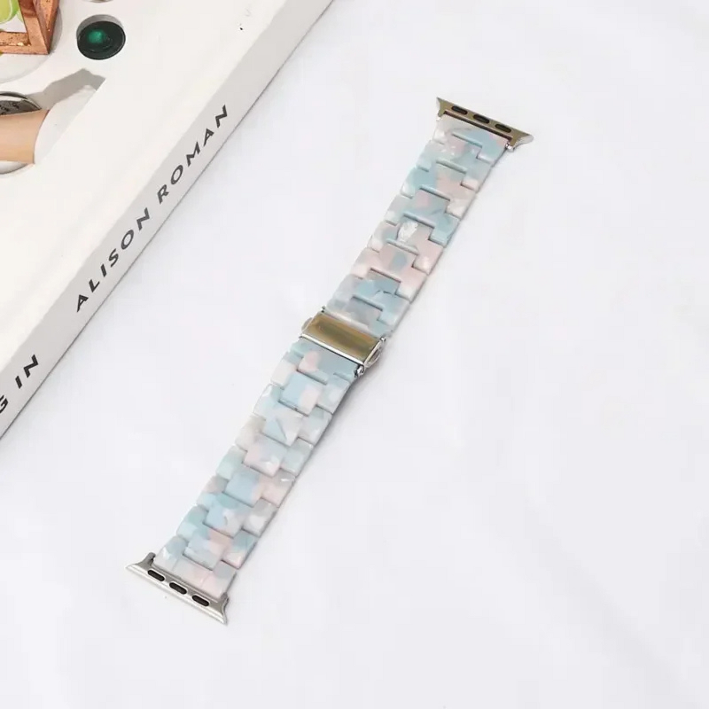 Bold marbled resin Apple Watch band with luminous high-gloss links and scratch-resistant adjustable fit