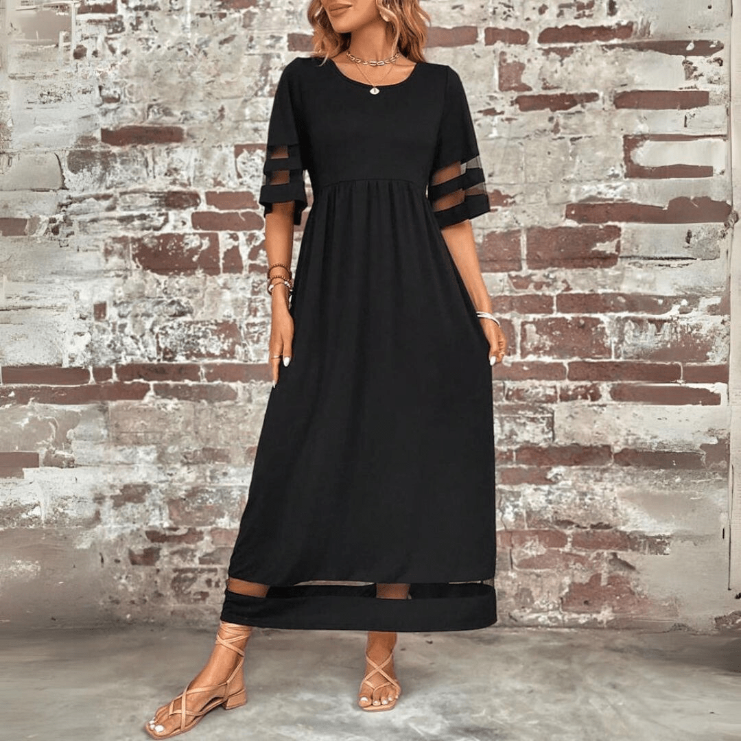 Black maxi dress with sheer sleeve panels, relaxed silhouette, raised waistline, round neckline