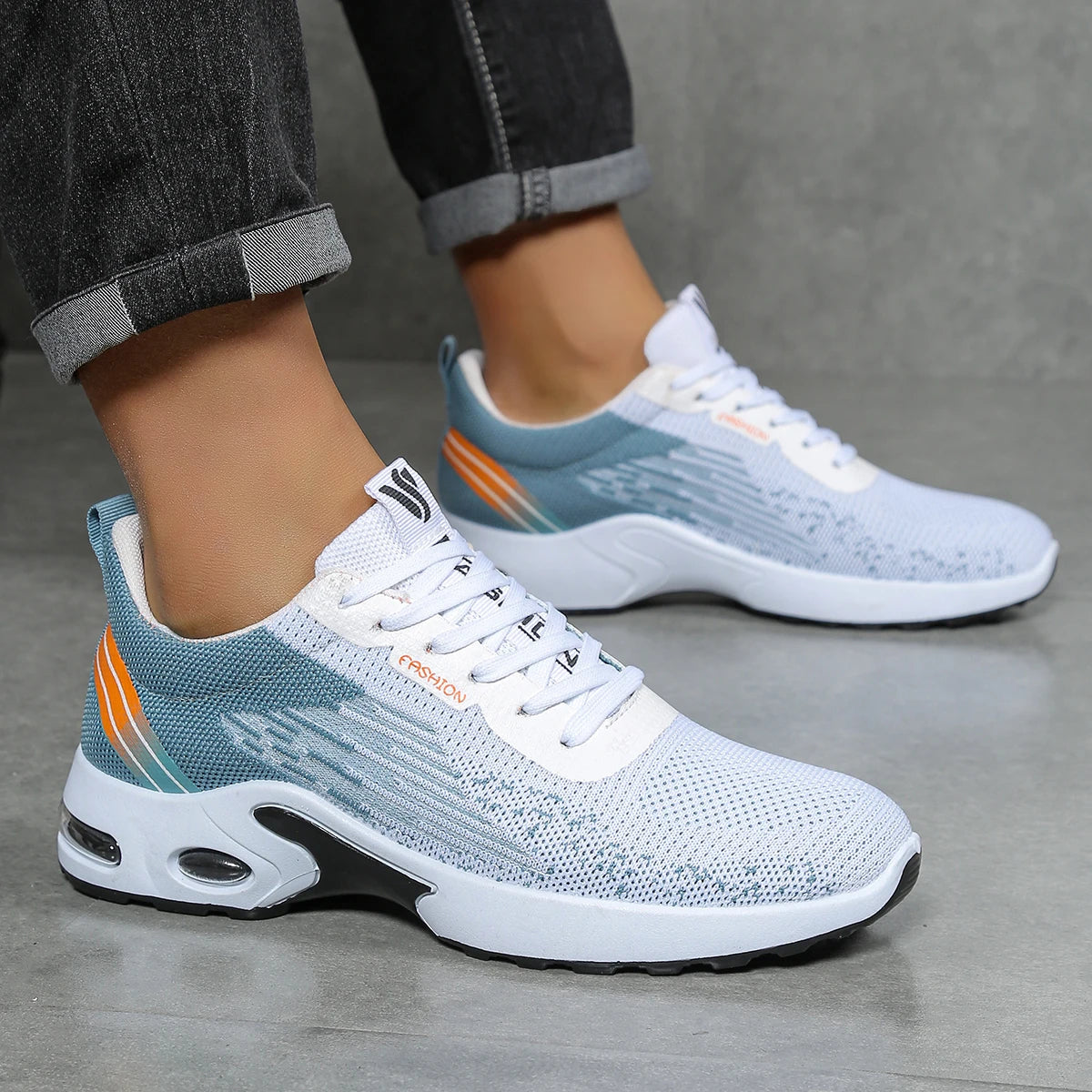 Lightweight white mesh sneaker with sock-fit knit upper and air cushioned sole for active daily wear