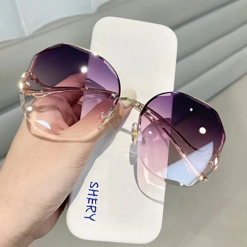 Women's rimless butterfly sunglasses gradient UV400 lenses bold petal-cut frames gold-tone temples