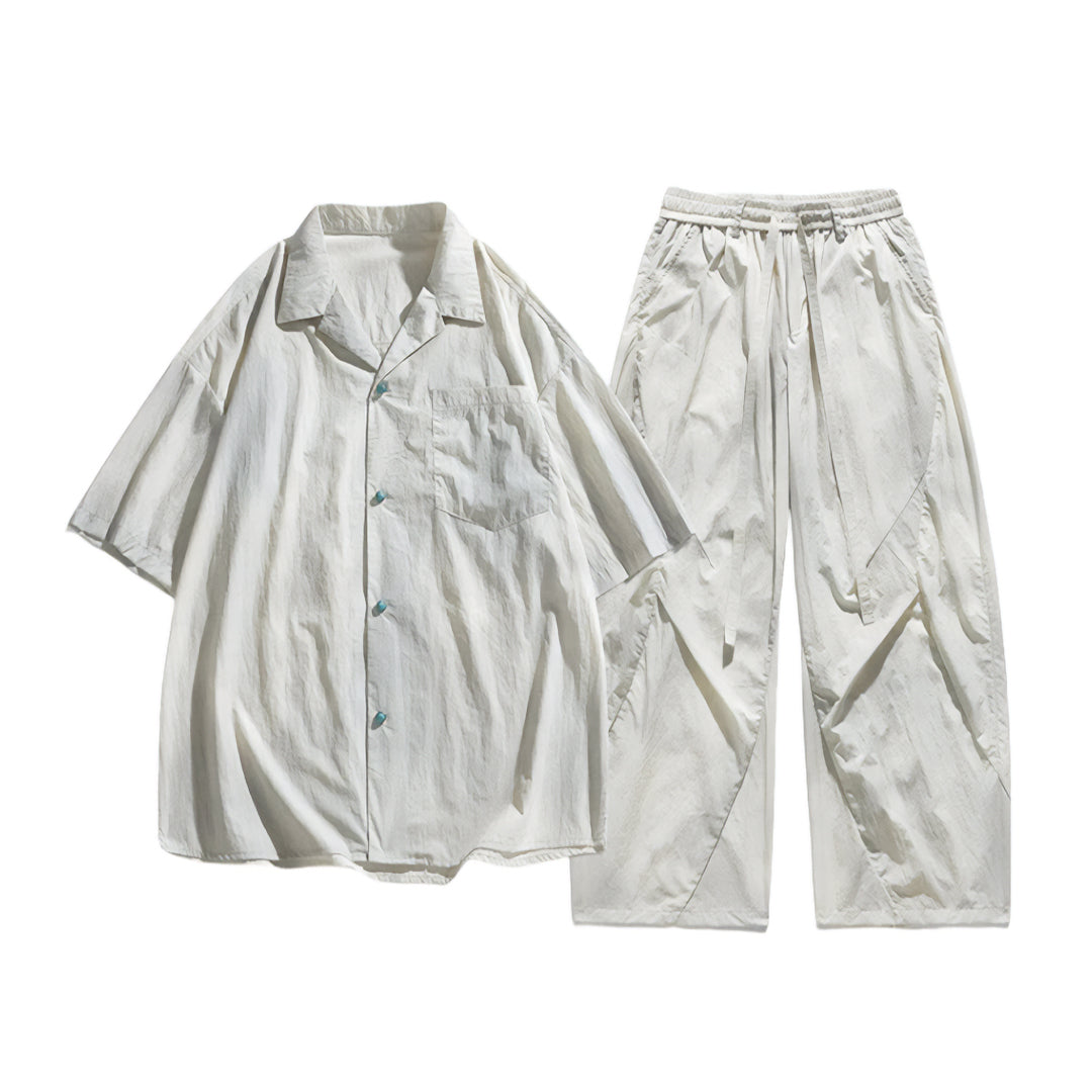 Turquoise nylon two-piece set with elastic waistband and button accents, lightweight matching shirt and pants