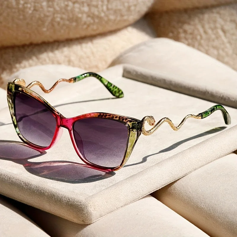 Oversized cat-eye sunglasses with sculpted snake arms, electric acetate frames, UV400 sun protection