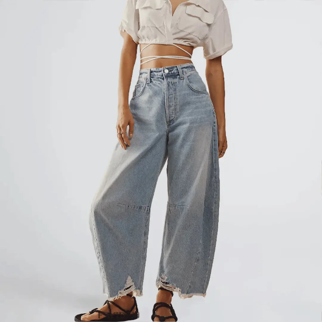 Vintage high-rise wide-leg distressed denim jeans with 90s flare silhouette in classic blue