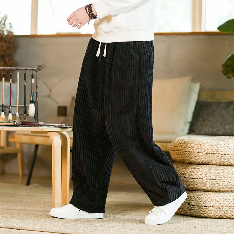 Women's brown corduroy wide-leg pants with relaxed fit, drawstring waist, and soft ribbed texture