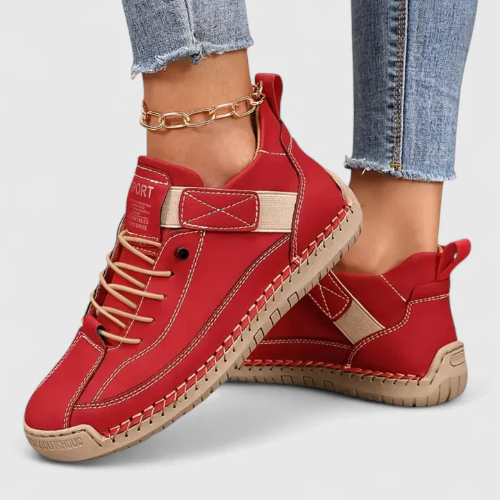 White high-top sneakers with stitched panels, lace-up front, adjustable strap, and structured urban silhouette