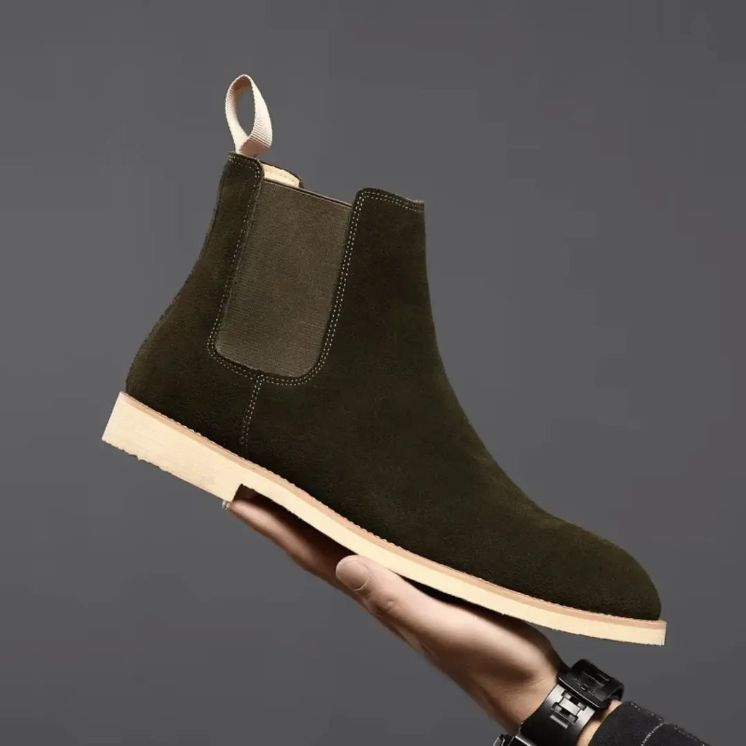 Olive green suede Chelsea boots with elastic side panels and sleek slip-on silhouette