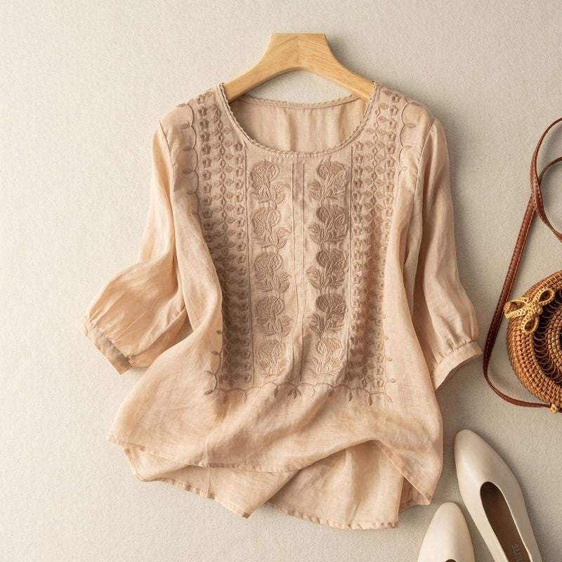 White linen blouse with stitched floral texture and curved high-low dipped hem for women