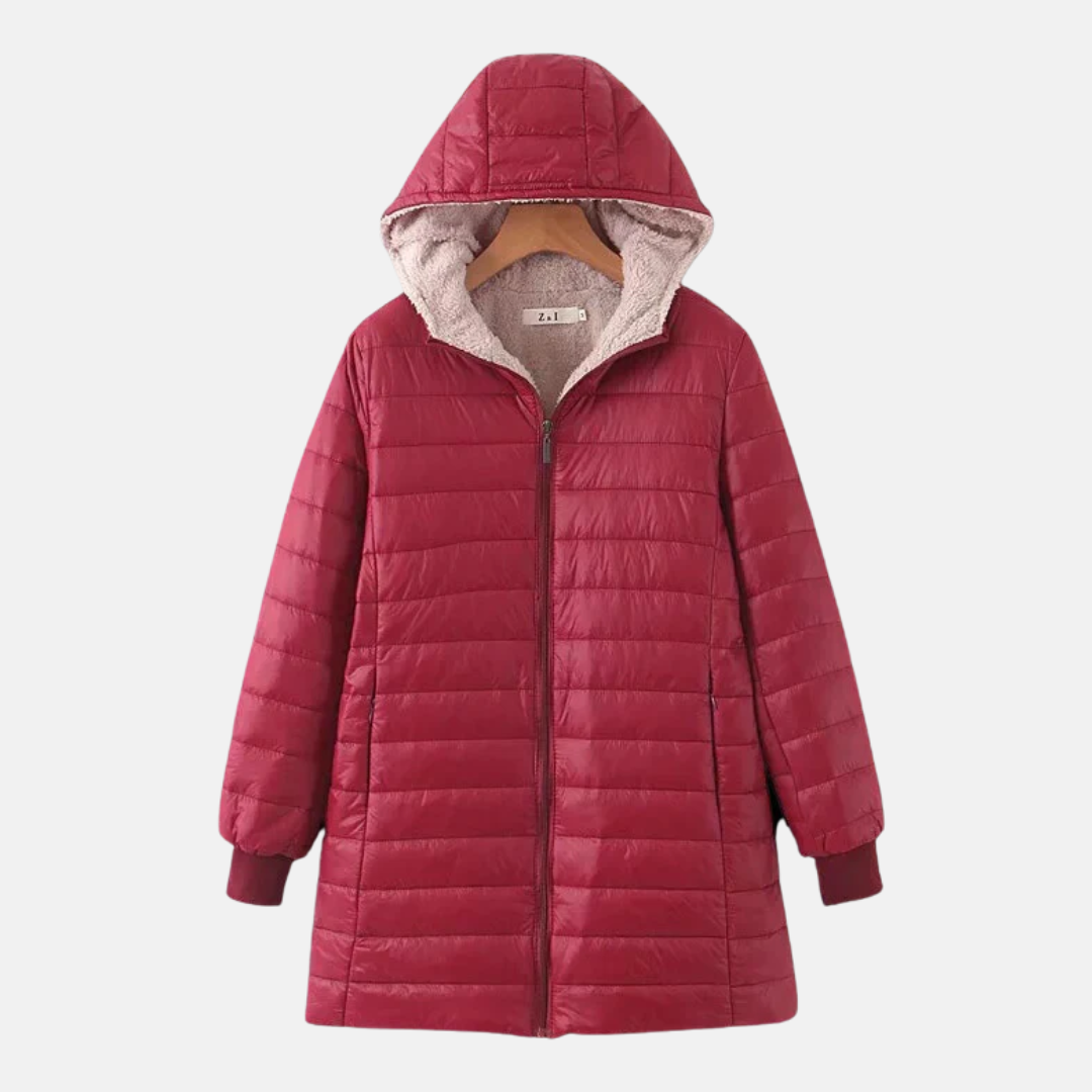 Women's mid-length quilted coat with attached hood, fleece-lined insulation, and ribbed cuffs for cold weather