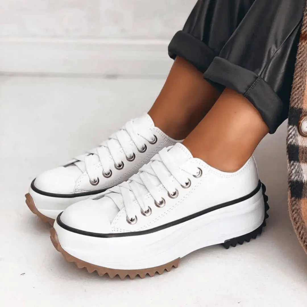 Women's chunky white canvas sneakers with slim molded platform and leather accent details