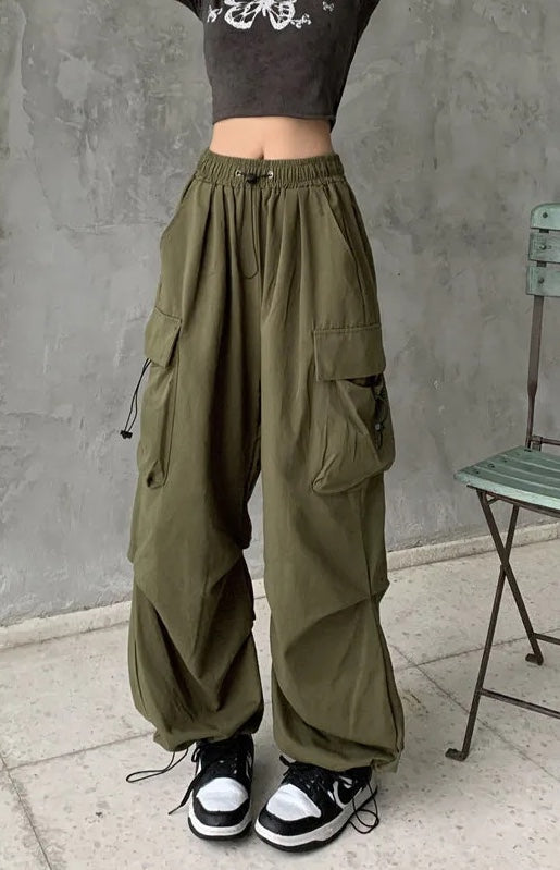 Olive oversized wide-leg cargo pants with multi-pocket design and adjustable elastic waist in breathable cotton blend