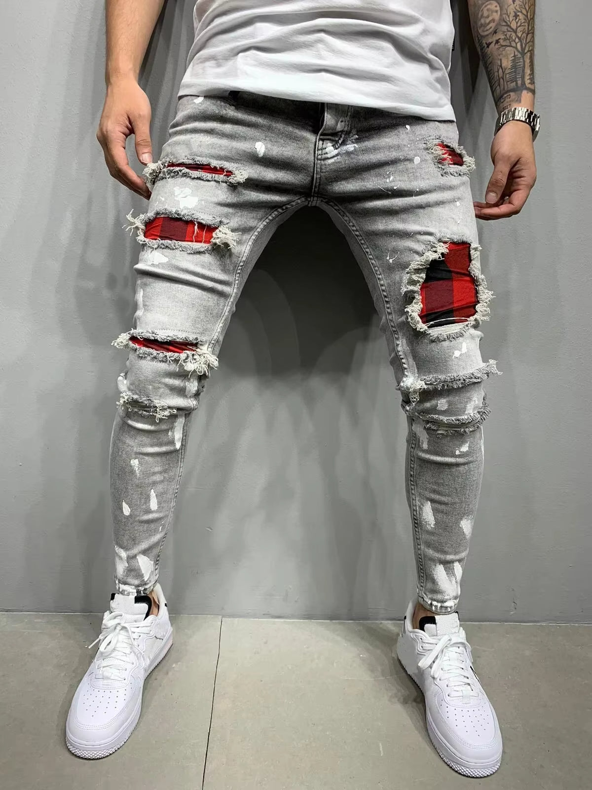 Rebel distressed tapered stretch denim pants with layered high-contrast distressing for streetwear stack fit