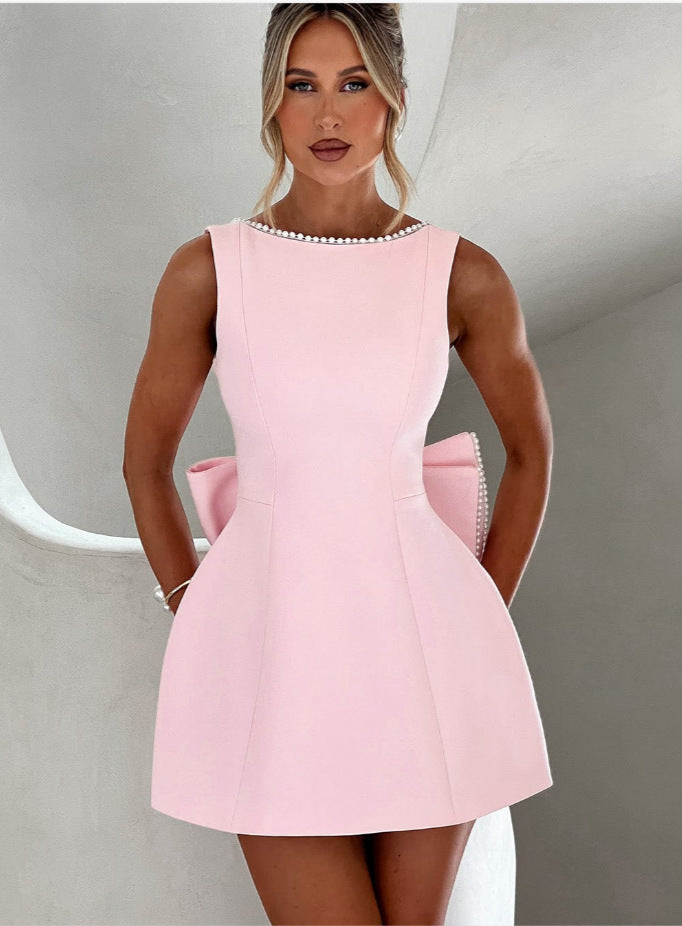 White flared mini cocktail dress with pearl accents, elegant sleeveless design for special occasions