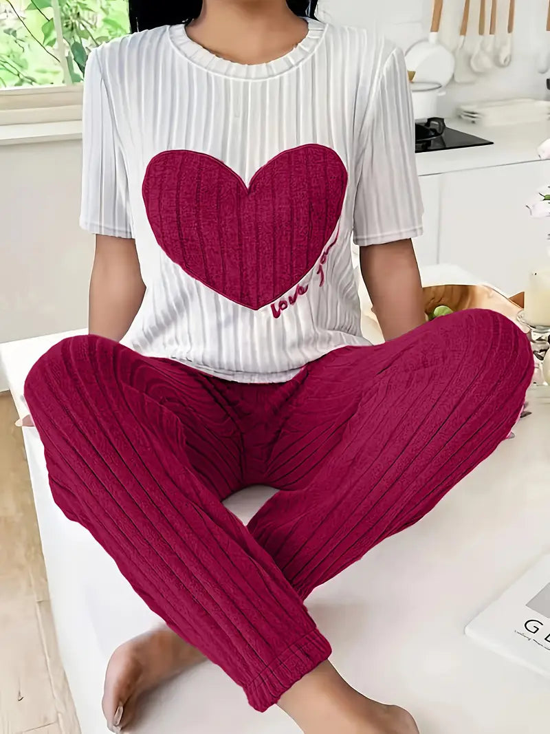 Women's ribbed knit loungewear set in neutral tones with oversized heart motif, cozy two-piece style