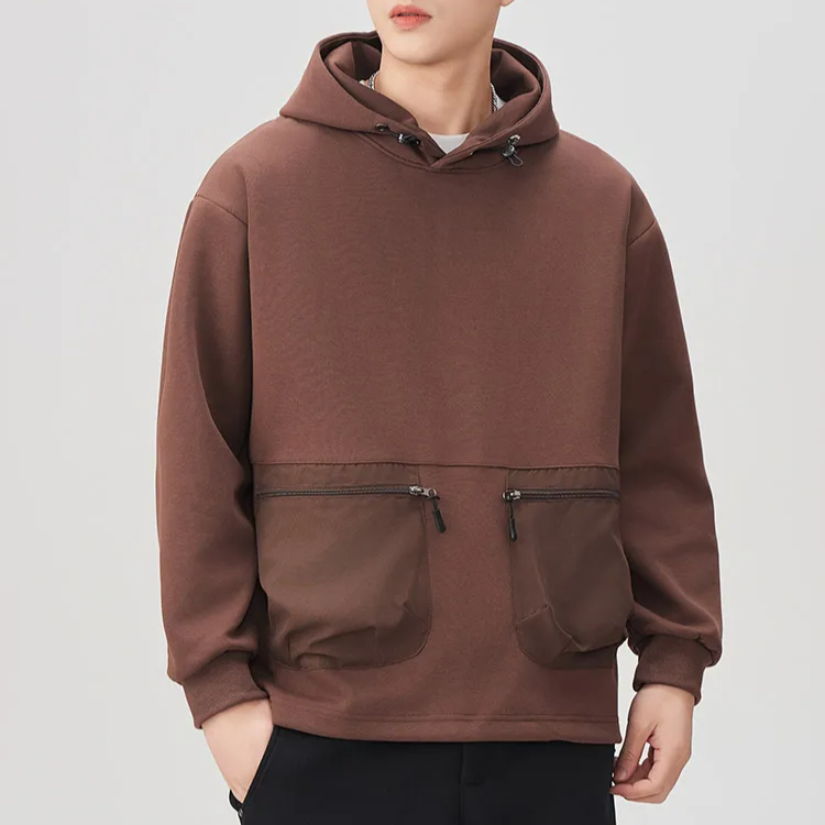 Military green boxy pullover hoodie with contrast panels and dual zip utility pockets