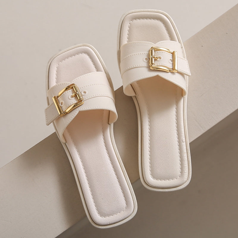 Beige orthopedic sandals with cushioned sole, square toe, curved strap, and gold-finish hardware