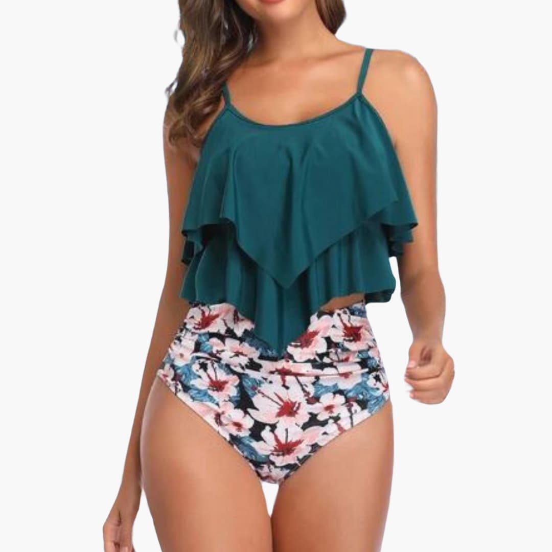 Women's blue tankini set with ruffled top and high-waisted tummy control bottom for beach