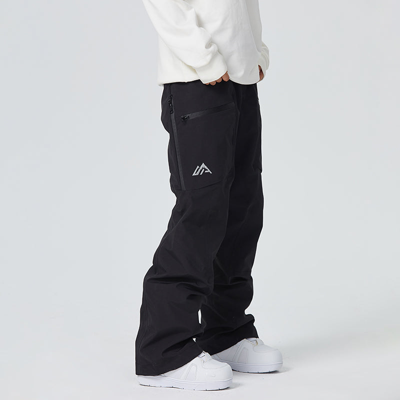Women's waterproof snow pants in black with thigh vents, taped seams, and boot gaiters for skiing