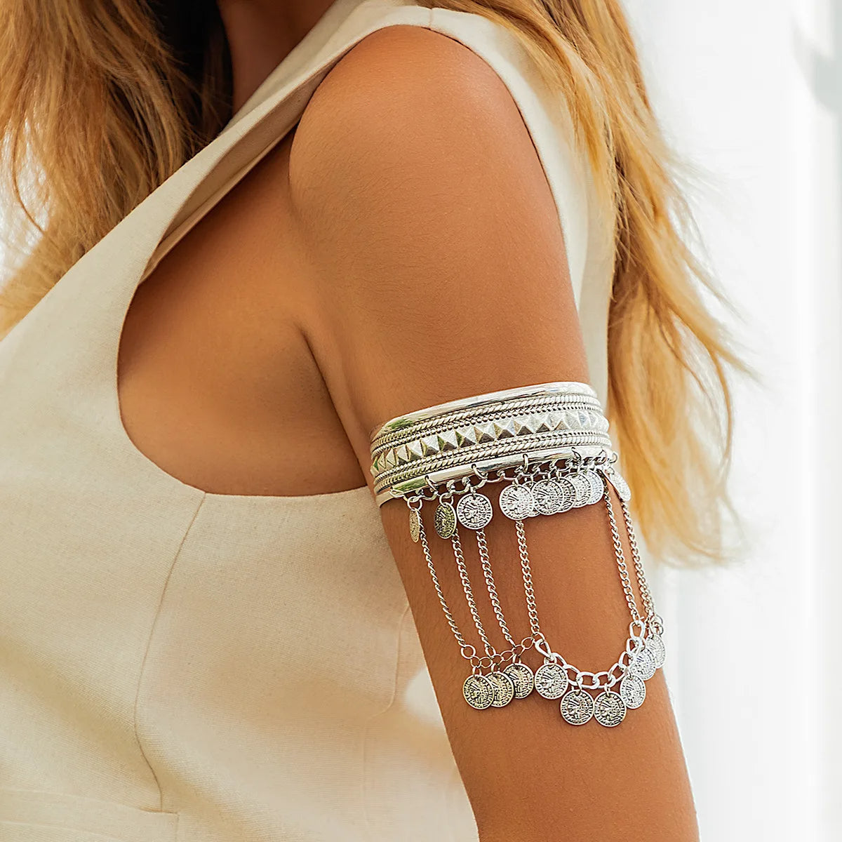 Gold armlet cuff bangle with layered chains and pyramid studs, bold sculptural statement jewelry