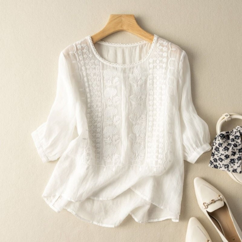 White linen blouse with stitched floral texture and curved high-low dipped hem for women