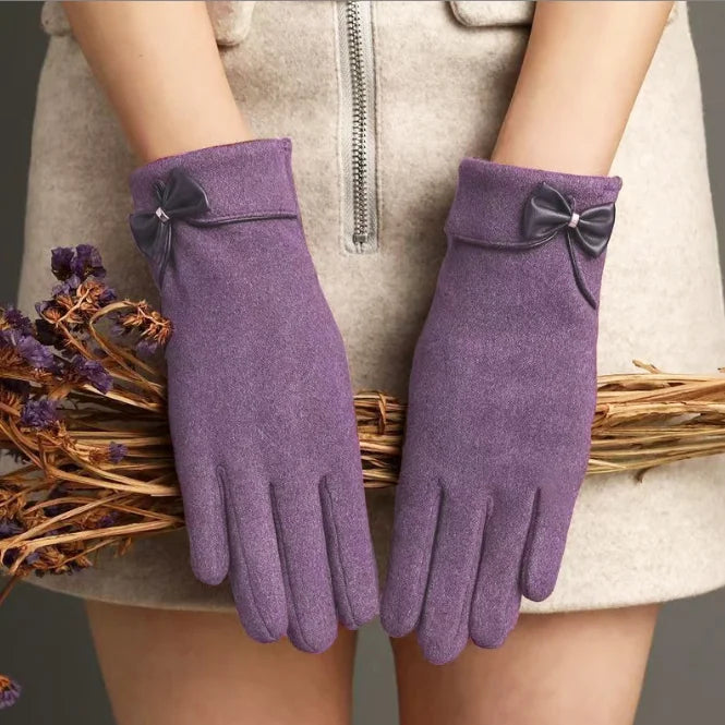 Women's beige suede winter gloves with wrist bow detail, touchscreen fingertips, and thermal fleece lining