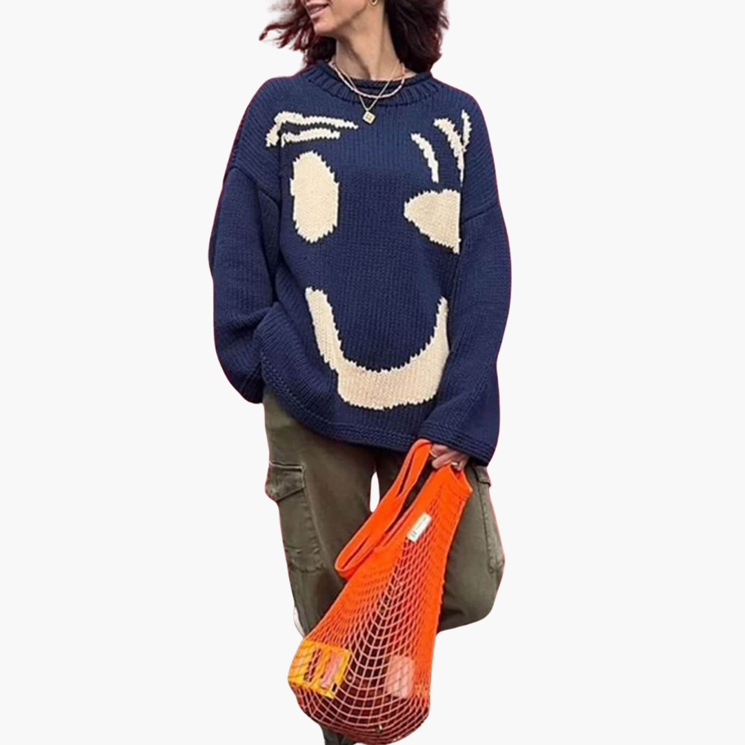 Women's oversized knitted sweater in neutral tones with playful smiley motif, cozy casual knitwear
