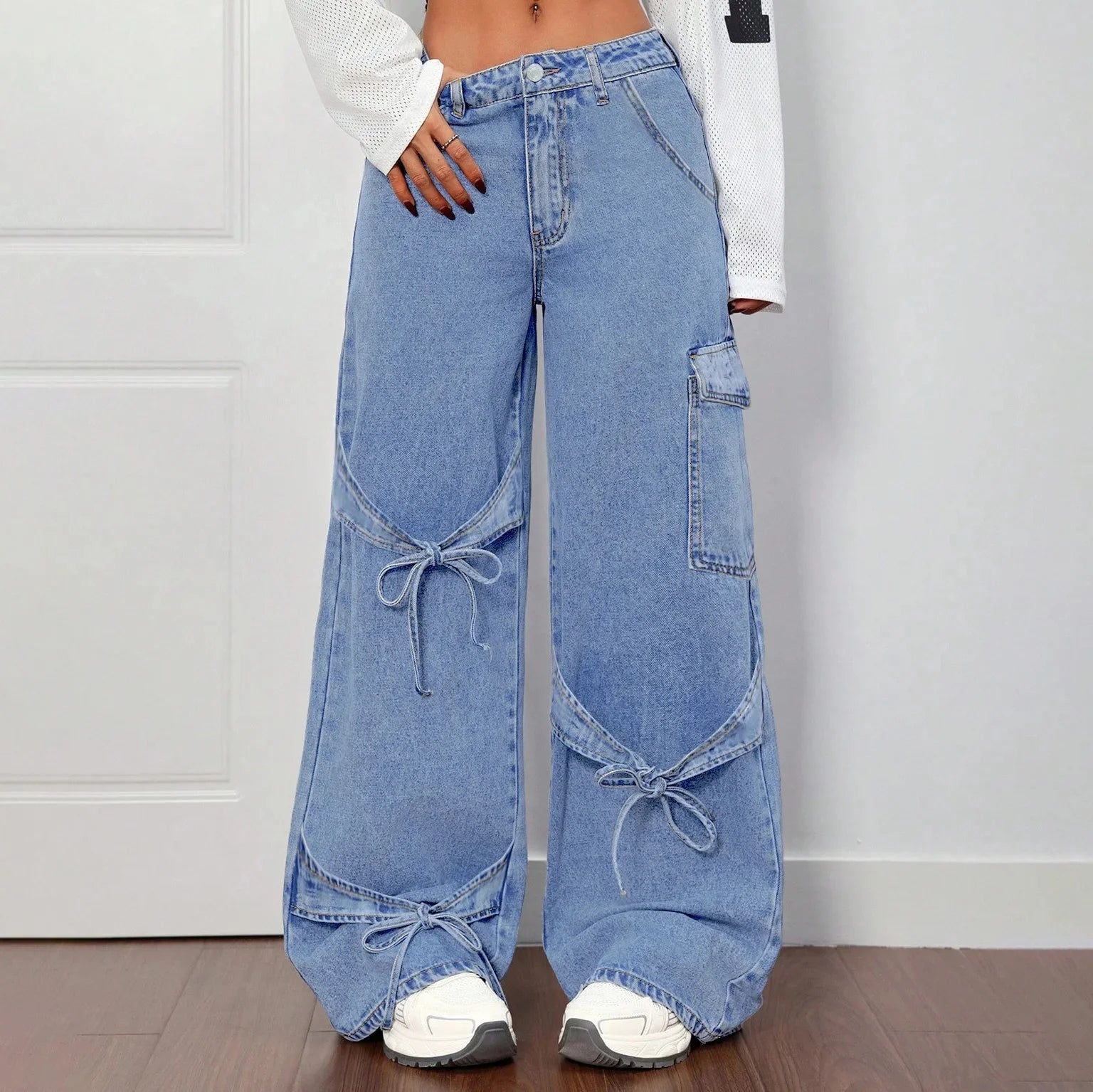 Women's wide-leg faded denim jeans high-waisted silhouette with bold bow-tie side detail