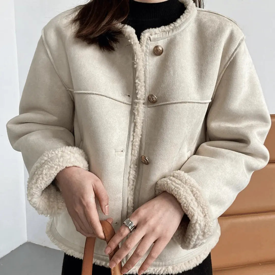 Women's suede sherpa jacket with plush shearling lining, structured silhouette, bold warm style