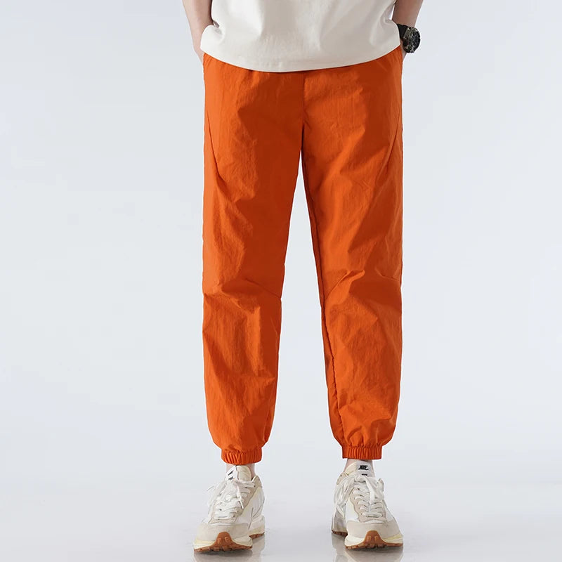 Men's black tapered nylon jogger pants lightweight quick-dry activewear sleek modern silhouette