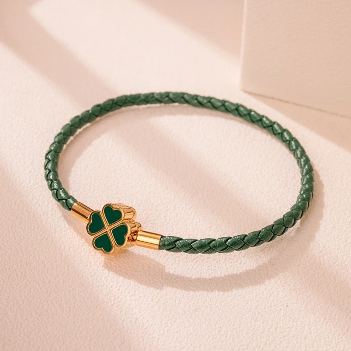 Hand-braided cowhide leather bracelet with 18K gold four-leaf clover charm, hypoallergenic tarnish-resistant