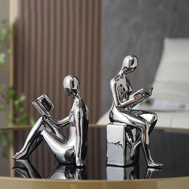 Set of 2 glossy gold resin bookends featuring abstract contemplative reading figures for elegant home libraries