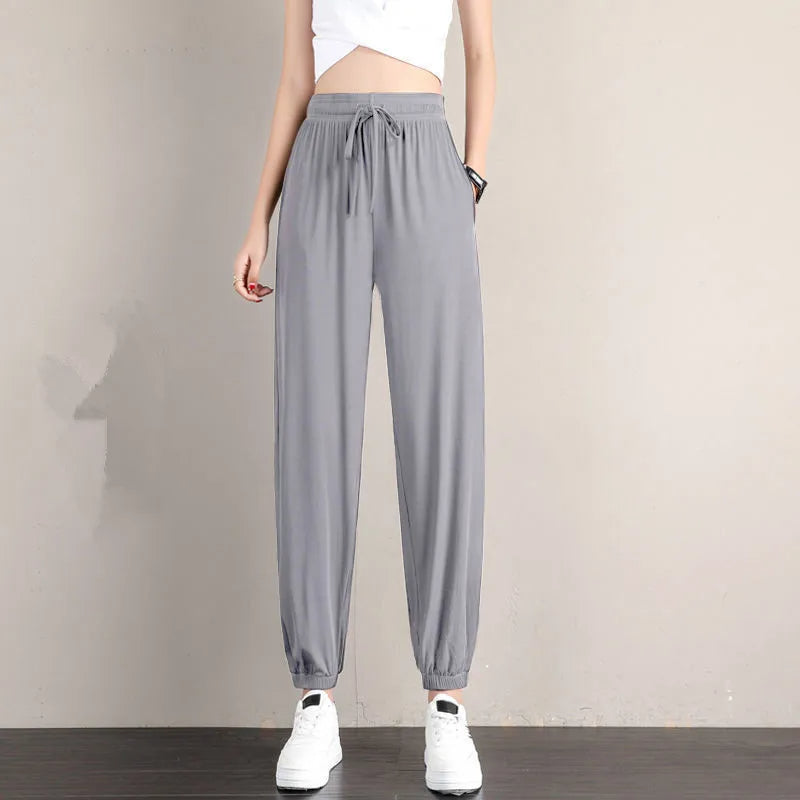Black tapered jogger pants with adjustable drawstring waistband, elastic cuffs, and side pockets