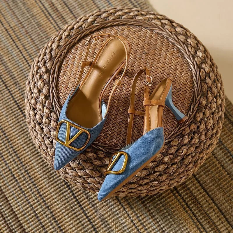 Nude slingback stiletto heel with pointed toe, adjustable ankle strap, and bold oversized buckle