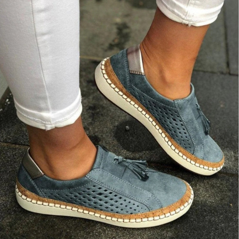Women's white perforated slip-on sneakers with flexible sole and breathable mesh-style upper
