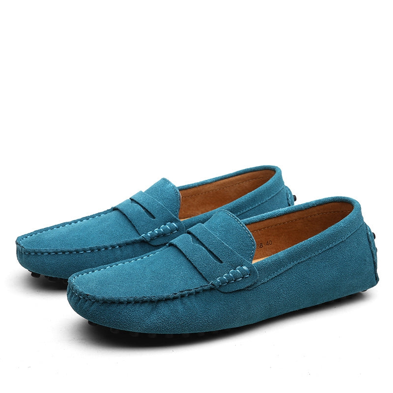 Men's brown suede loafers with cushioned lining, detailed stitching, and rubber grip outsole