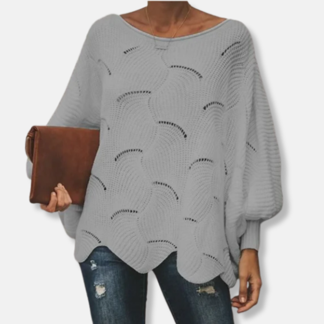 Women's relaxed fit batwing sleeve sweater with boat neck, open knit texture, and wavy hem