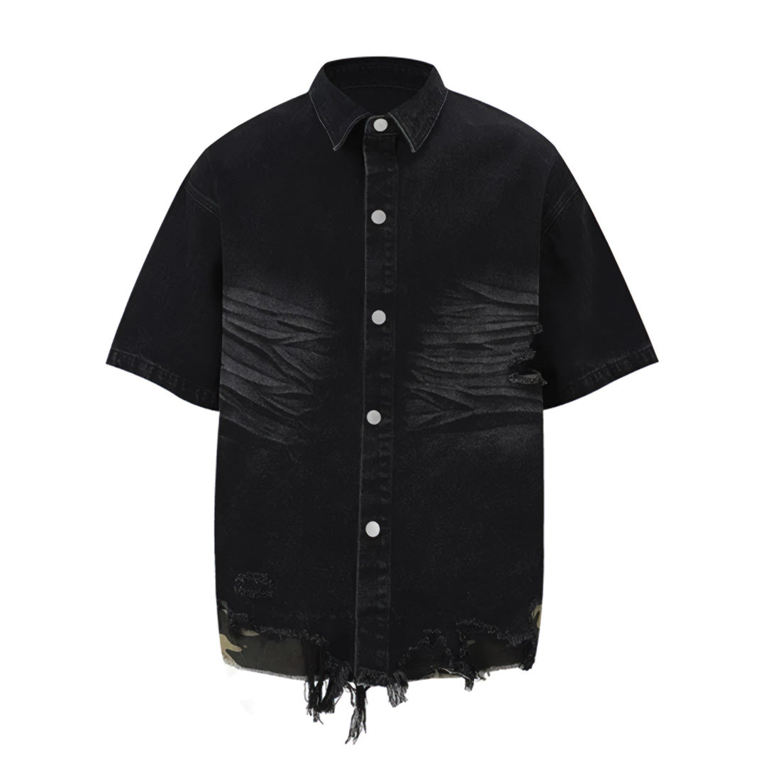 Light wash short sleeve denim shirt with distressed hem, camouflage panels, and raw ripped edges