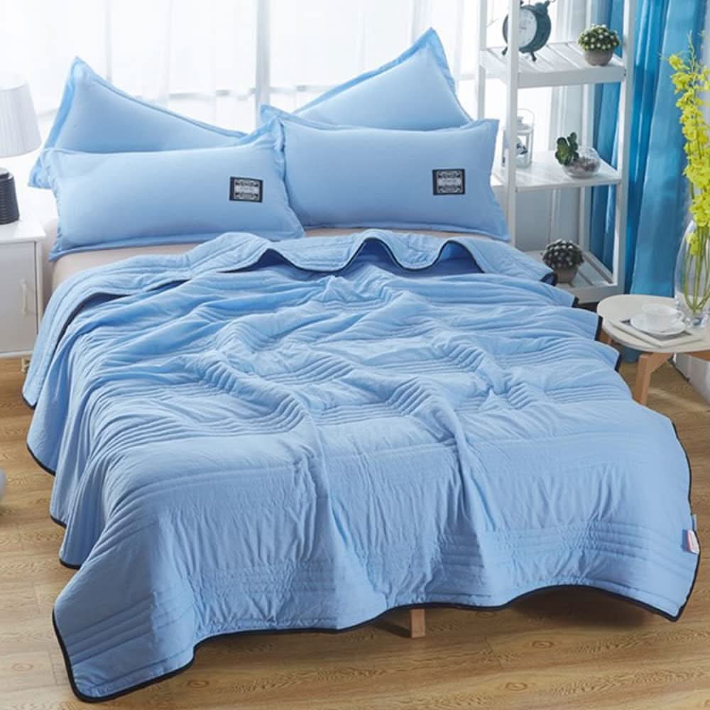 Lightweight cooling cotton blanket in soft pink with quilted texture, designed for all-night breathable comfort
