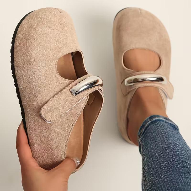Women's suede slip-on shoes with sculpted sole and bold metallic clasp accent for everyday wear