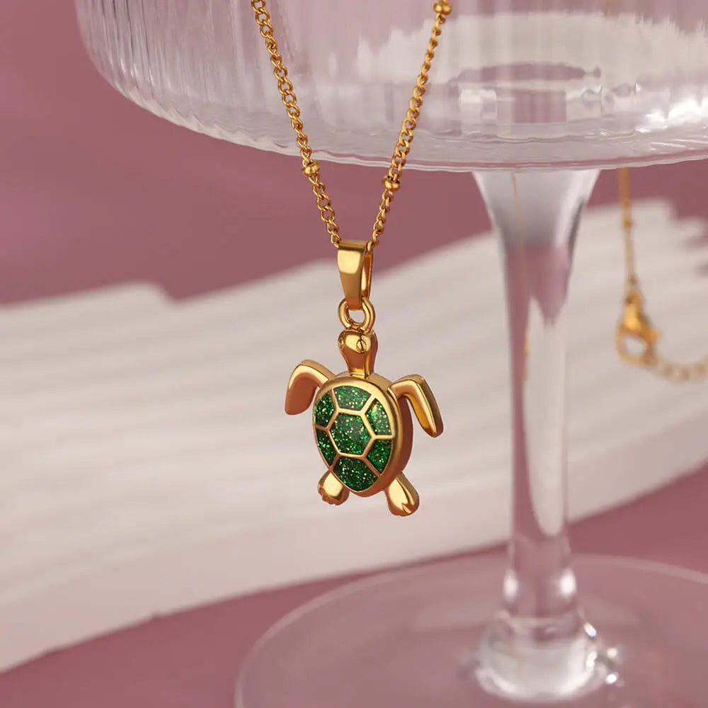 Gold-tone stainless steel turtle pendant necklace with shimmering enamel inlay, adjustable chain for women