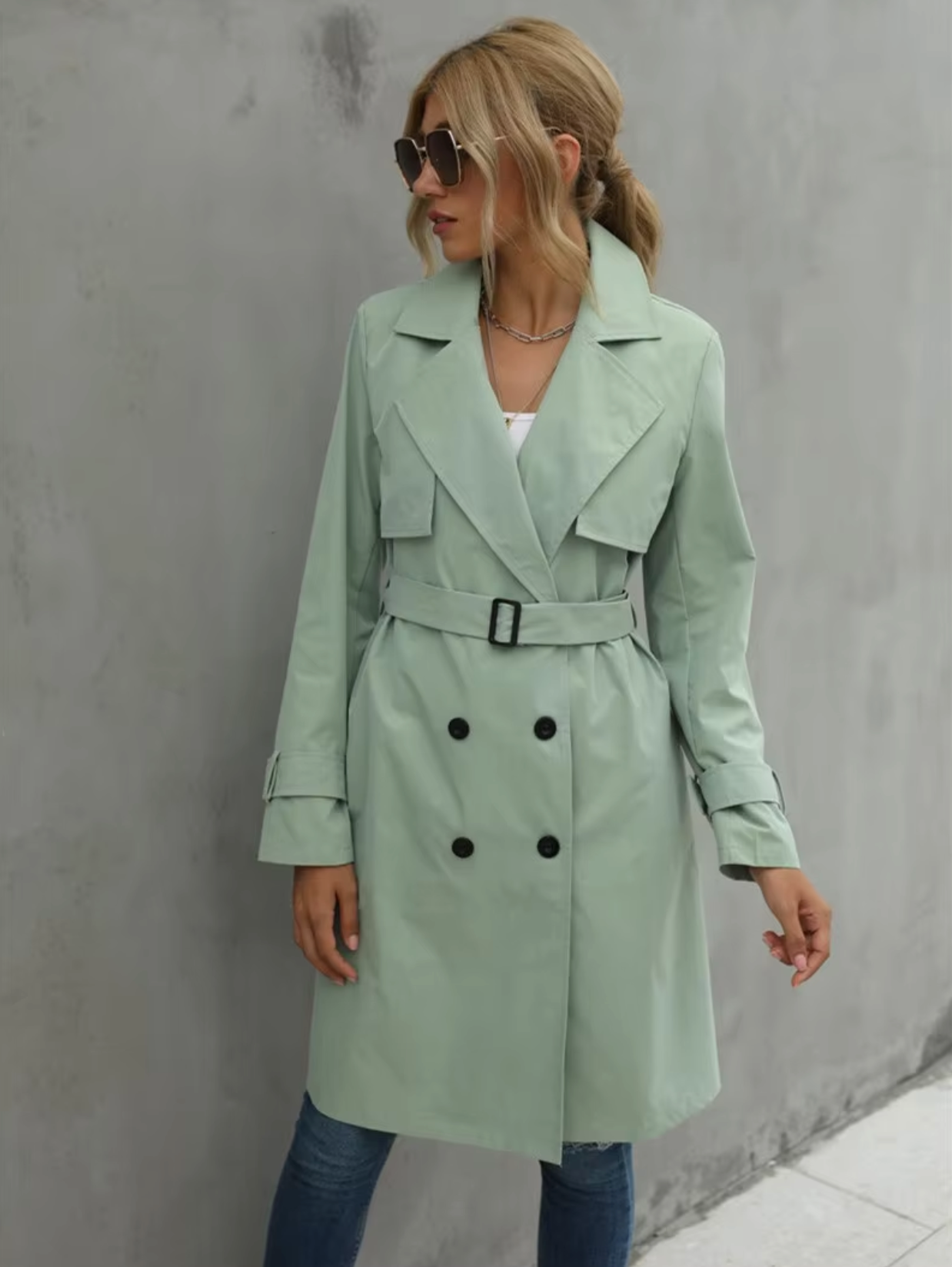 Beige women's double-breasted belted trench coat with structured tailored silhouette