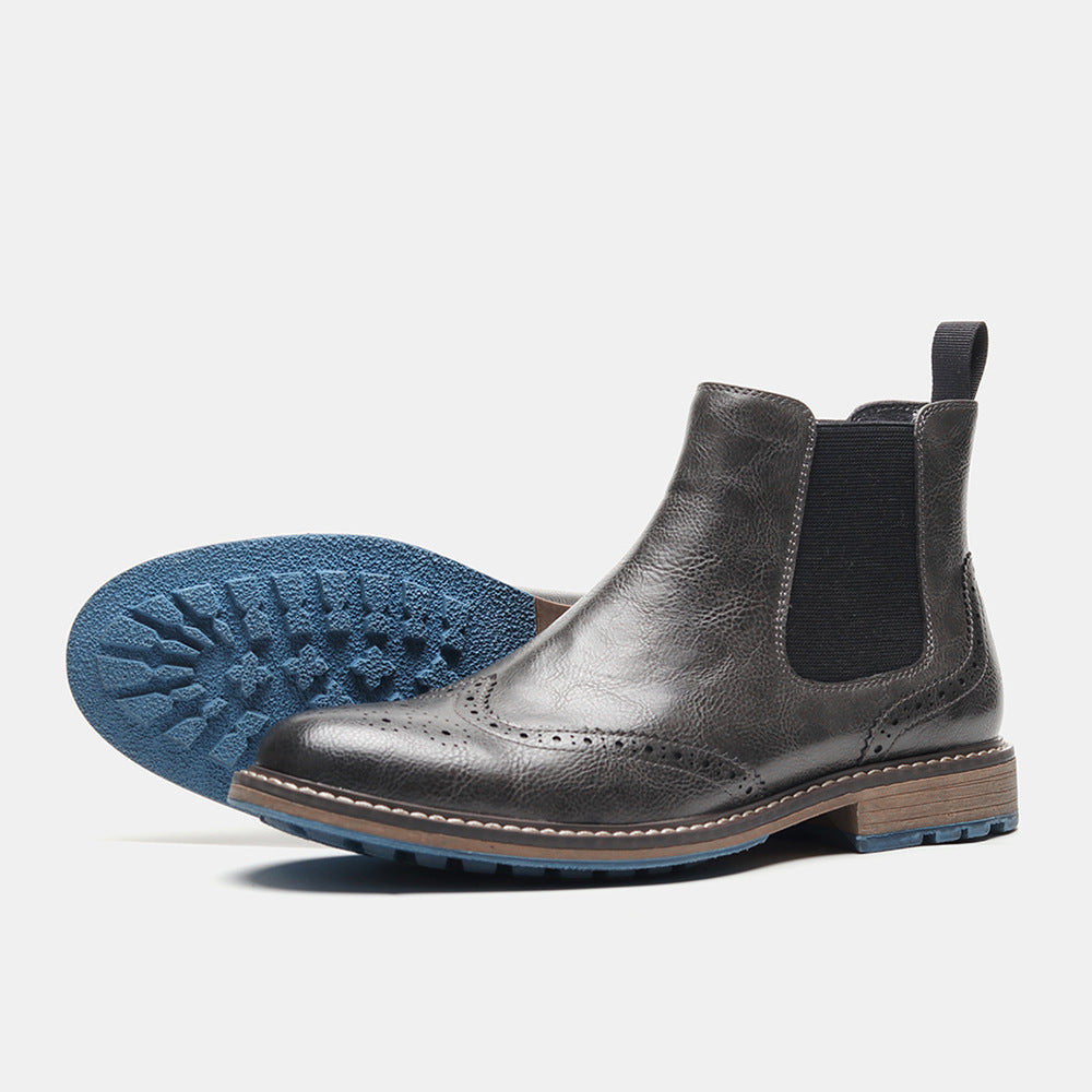 Men's brown leather Chelsea boots with brogue toe perforations, elastic sides, sleek timeless silhouette