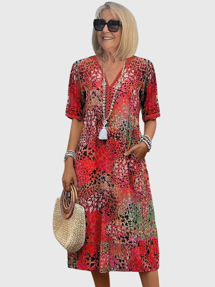 Women's printed midi dress with V-neckline, relaxed drape silhouette, short sleeves, effortless everyday style